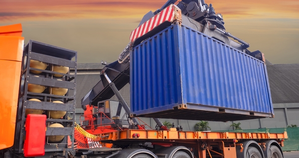 Shipping container being loaded onto a truck for international shipping with Shipa Freight