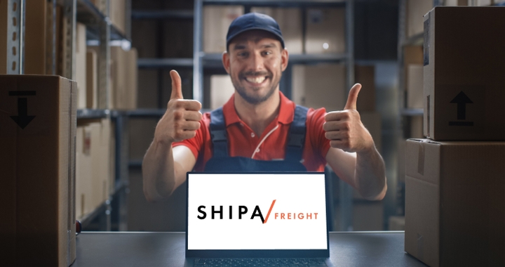 Shipa Freight logo on computer with a warehouse operator showing two thumbs up.