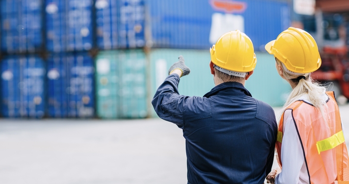 Two people looking at a container to represent the shipper when shipping with Shipa Freight