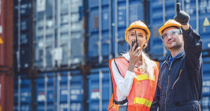 Two people looking at a container to represent the consignee when shipping with Shipa Freight