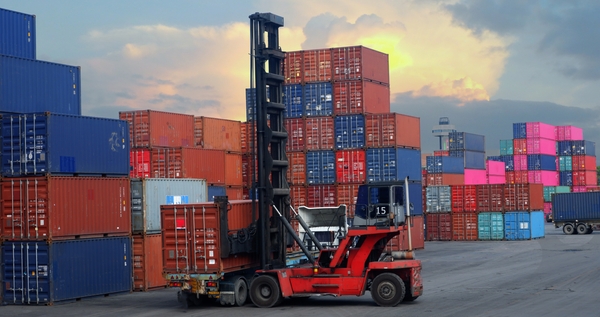 A transport vehicle loading containers in a container freight station for when you're shipping withShipa Freight