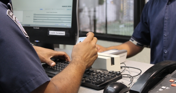 customs official checking an ID for customs inspections when shipping internationally with Shipa Freight