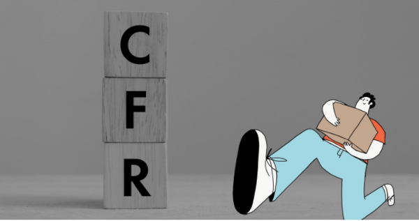 Person standing next cubes spelling CFR for the Incoterm cost and freight when shipping with Shipa Freight.