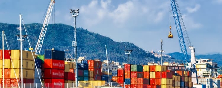 Cargo port next to hills with cranes working