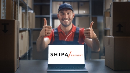 Shipa Freight logo on computer with a warehouse operator showing two thumbs up.