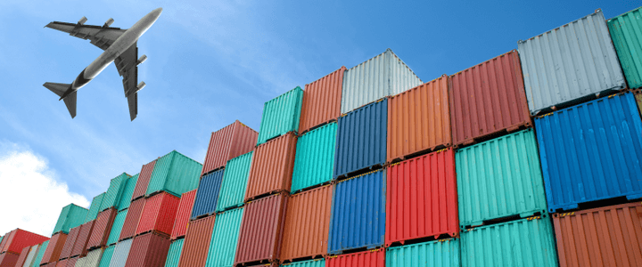 Containers stacked on top of each other with airplane flying over them to represent shipping with Shipa Freight