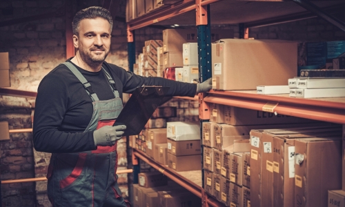 Worker holding note pad in a warehouse