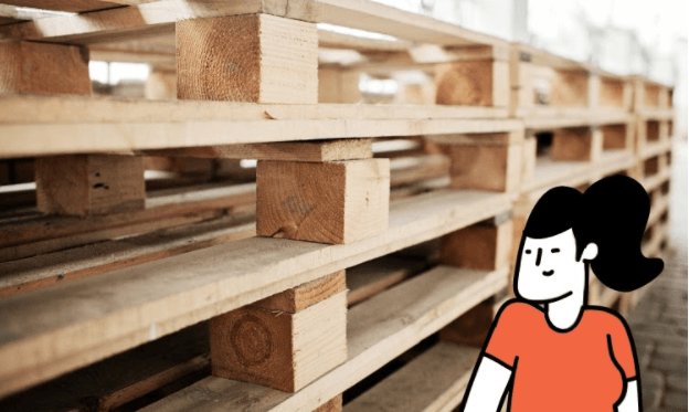 Person standing next to different kind of pallets.